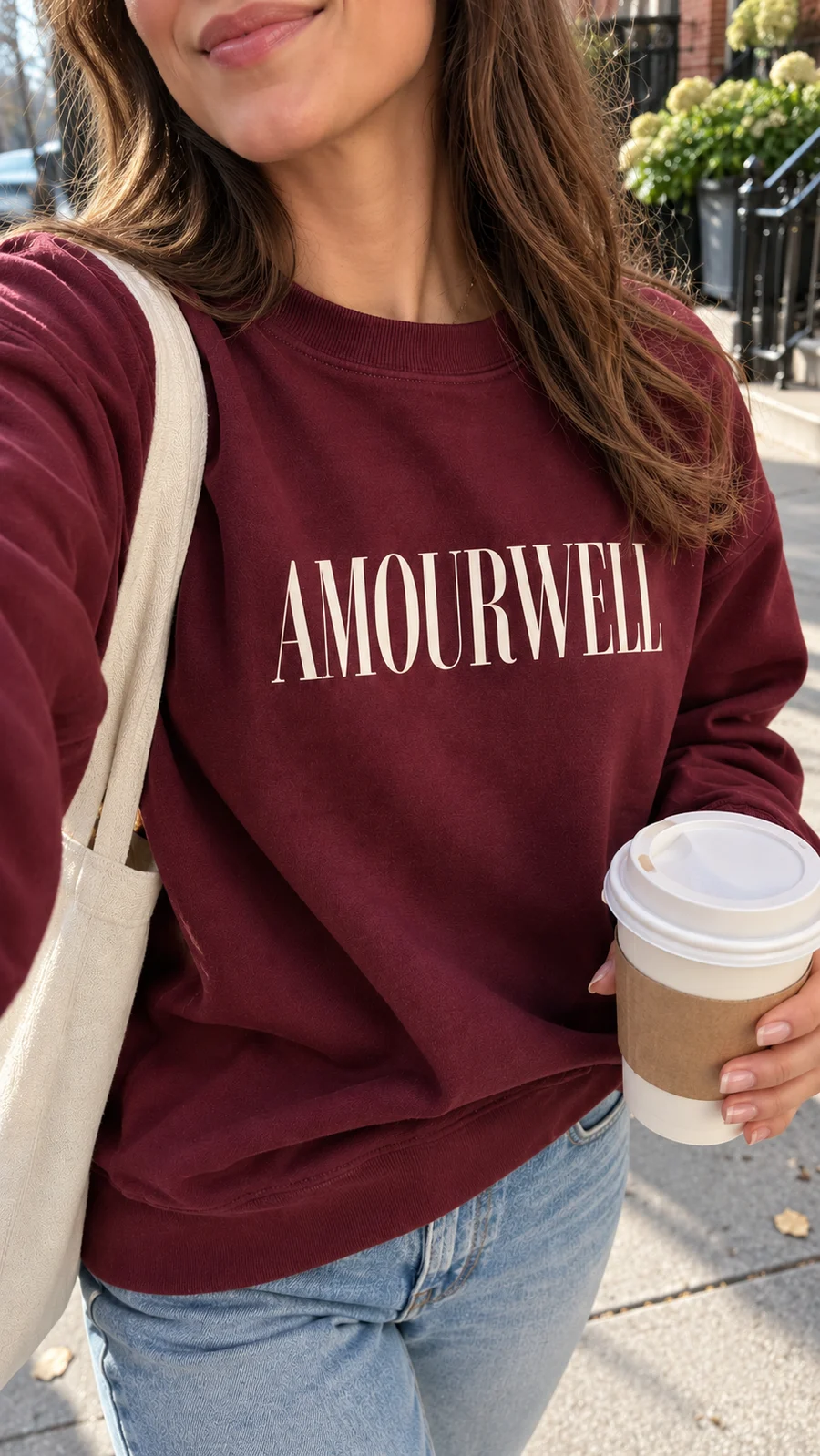 Burgundy Amourwell sweatshirt and a coffee to go